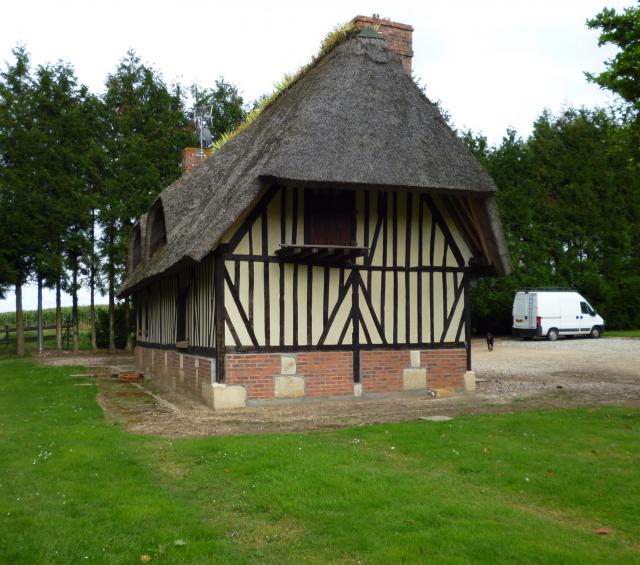 Timber framed house with a thatched roof in Le Favril (Eure) in France.