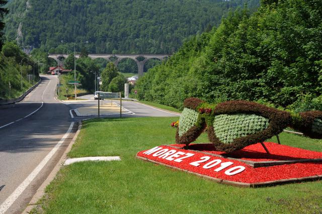 Road entering the town of Morez; Doubs, France. Glasses as a symbol for the main product of the town.