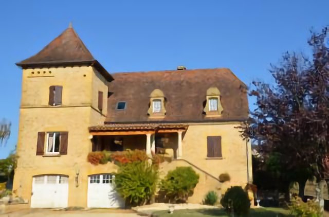 Traditional house in Dordogne region with the famous towers for pigeons: see the holes in the wall!