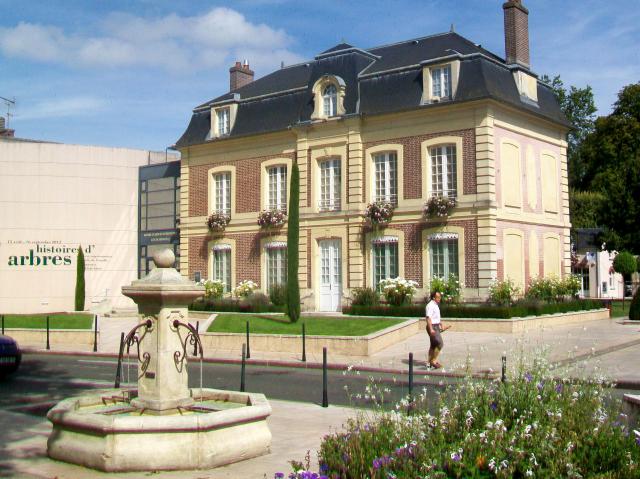 Le centre d'art Jacques-Henri Lartigue ; façade sur la Grande rue et fontaine devant le commissariat.